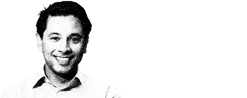 Professional headshot of a smiling man.